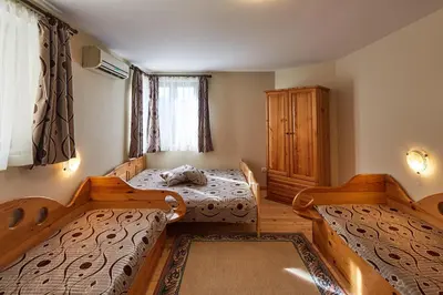 a bedroom with two beds and a dresser at Guest House Mira in Sapareva Banya
