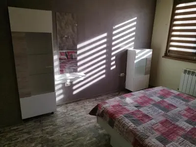 a bedroom with a bed and a sink in a room at Heart of Pernik apartment in Pernik