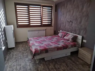 a small bedroom with a bed and a window at Heart of Pernik apartment in Pernik