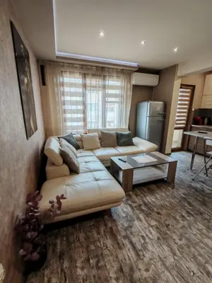 a living room with a couch and a table at Heart of Pernik apartment in Pernik