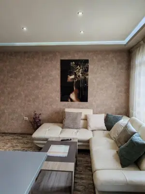 a living room with a couch and a table at Heart of Pernik apartment in Pernik