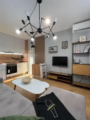 a living room with a couch and a table at Cozy Boutique Apartment in Plovdiv in Plovdiv