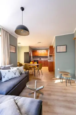 a living room with a couch and a table at Cedar Lodge III 2 BDRM Flat B12 in Bansko