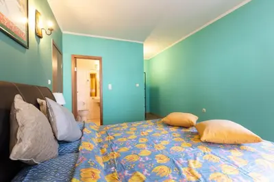 a blue bedroom with a bed with pillows on it at Cedar Lodge III 2 BDRM Flat B12 in Bansko