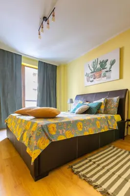 a bedroom with a large bed with a colorful bedspread at Cedar Lodge III 2 BDRM Flat B12 in Bansko