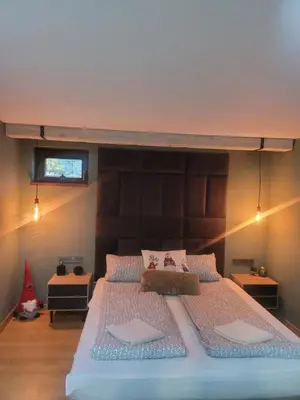a bedroom with a large bed with a wooden headboard at BH and Semiramida Ski Apartment in Borovets
