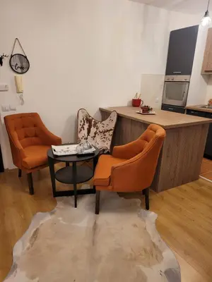 two orange chairs and a table in a kitchen at BH and Semiramida Ski Apartment in Borovets