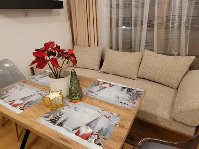 a living room with a table and a couch at BH and Semiramida Ski Apartment in Borovets