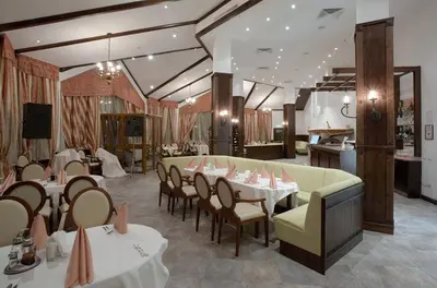 a restaurant with tables and chairs in a room at BH and Semiramida Ski Apartment in Borovets