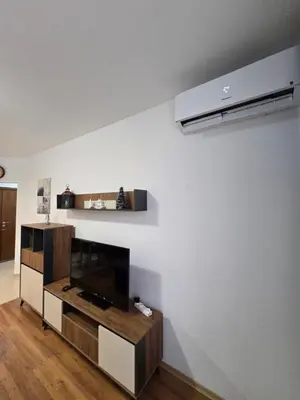 a living room with a flat screen tv on a wall at Апартамент В204 Belvedere Holiday Club in Bansko