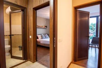 a room with a bedroom with a bed and a mirror at Apartment with private parking 1 in Sofia