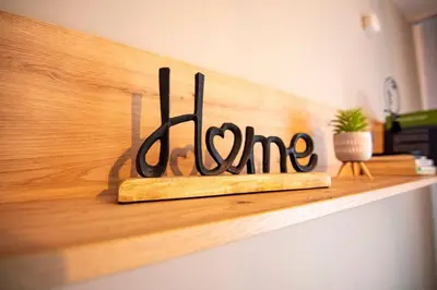 a sign that says love on a wooden shelf at Apartment with private parking 1 in Sofia