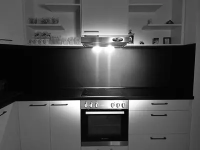 a kitchen with a stove and white cabinets at The white suite in Sofia