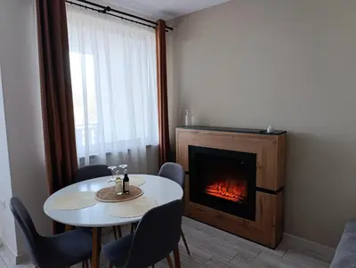 a dining room with a table and a fireplace at Apartment B45 Borovets Gardans in Borovets