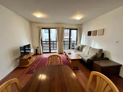 a living room with a couch and a table at Gramadeto two bedroom apartment next to Gondola in Bansko