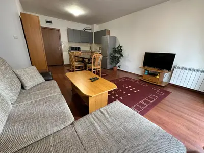 a living room with a couch and a table at Gramadeto two bedroom apartment next to Gondola in Bansko