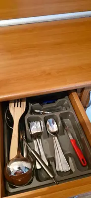 a drawer filled with kitchen utensils in a cabinet at Уютная квартира в комплексе Snow Lodge in Bansko