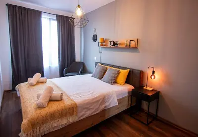 a bedroom with a bed with two towels on it at Аpartment with Free Parking in Sofia