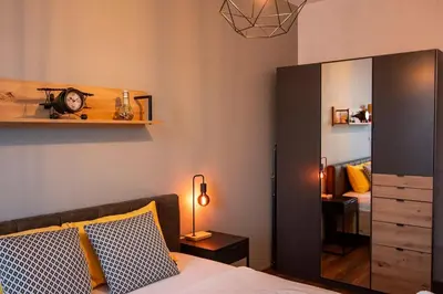 a bedroom with a bed with a mirror and a desk at Аpartment with Free Parking in Sofia