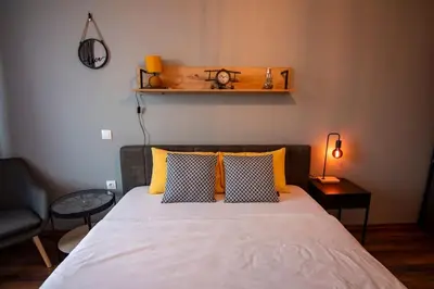 a bedroom with a bed with yellow pillows and a shelf at Аpartment with Free Parking in Sofia
