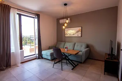 a living room with a couch and a table at Аpartment with Free Parking in Sofia
