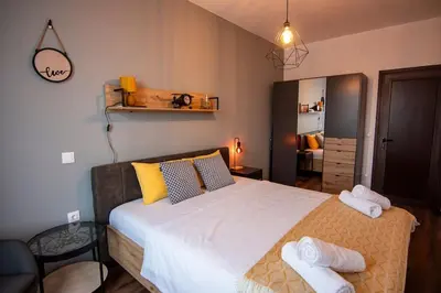a bedroom with a large bed with towels on it at Аpartment with Free Parking in Sofia