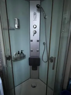 a shower in a bathroom with a glass door at Casa del Rey in Sofia