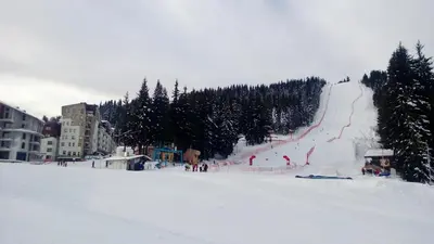 a ski slope with people on it in the snow at Vadjo Apartments in Complex Stenata Pamporovo in Pamporovo