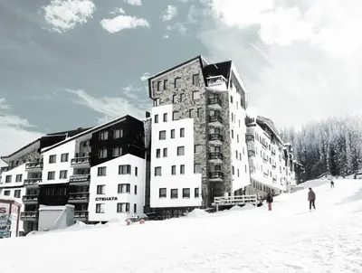 a large building on a ski slope in the snow at Vadjo Apartments in Complex Stenata Pamporovo in Pamporovo