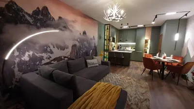 a living room with a large painting on the wall at Pinewood ANG premium luxurious apartment 15 in Borovets