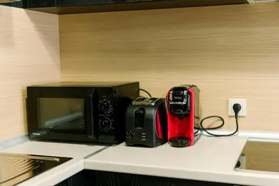 a microwave and a toaster on a kitchen counter at PANORAMA SPA ASPEN APARTMENT in Razlog