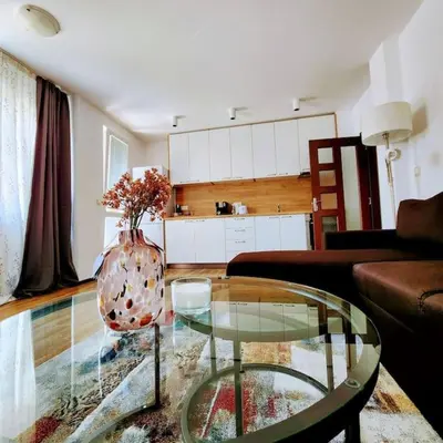 a living room with a glass table and a vase at Aпартамент-София/ Newhome lux apartment in Sofia