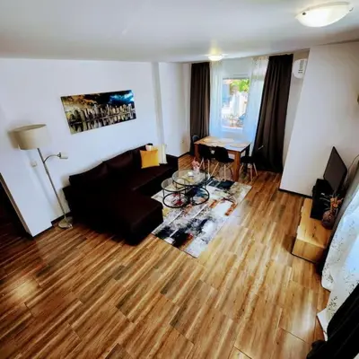 a living room with a couch and a table at Aпартамент-София/ Newhome lux apartment in Sofia