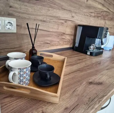 a counter with a tray with cups and a microwave at Aпартамент-София/ Newhome lux apartment in Sofia