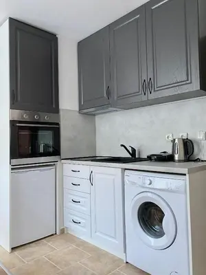 a kitchen with a washing machine and a dishwasher at Pirin Sense apartment A11 in Bansko