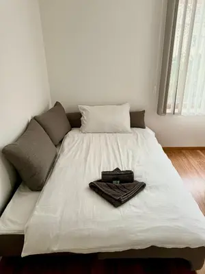 a white bed with a tray on top of it at Pirin Sense apartment A11 in Bansko
