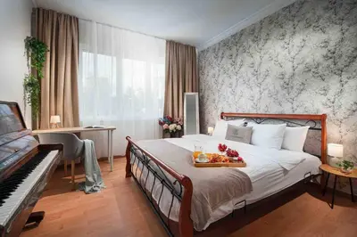 a hotel room with a bed and a piano at National Palace Of Culture 1 Step Away! in Sofia