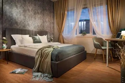 a bedroom with a large bed and a window at National Palace Of Culture 1 Step Away! in Sofia