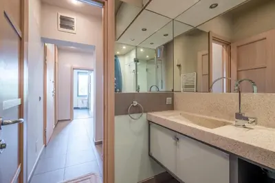 a bathroom with a sink and a large mirror at Modern yet Rustic Style City Centre Apt 2BR/2BTH in Sofia