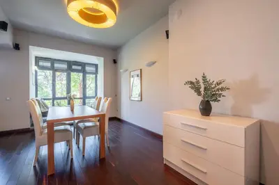 a dining room with a table and chairs and a dresser at Modern yet Rustic Style City Centre Apt 2BR/2BTH in Sofia