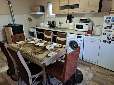 a kitchen with a table with leaves on it at Guest House Freya in Beli Iskar