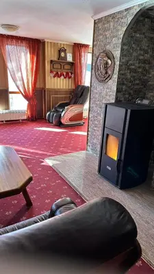 a living room with a fireplace and a tv at ELEA Apartment Mountain Lodge Pamporovo in Pamporovo