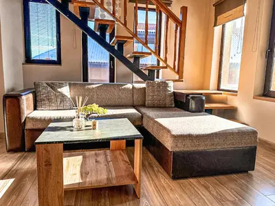 a living room with a couch and a table at IZ VIEW Apartment in Bansko