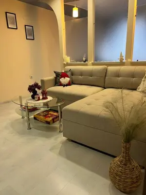 a living room with a couch and a table at Apartament Kamarashki in Troyan