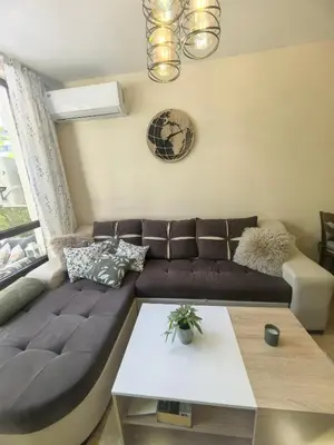 a living room with a couch and a table at Garden apartment Aspen Suites A008 in Bansko