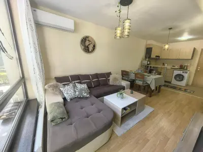 a living room with a couch and a table at Garden apartment Aspen Suites A008 in Bansko