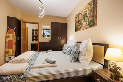 a bedroom with a bed with pillows on it at Garden apartment Aspen Suites A008 in Bansko