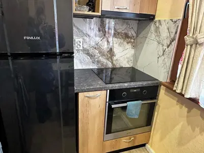 a kitchen with a black refrigerator and a stove at Апартамент Миели in Sofia
