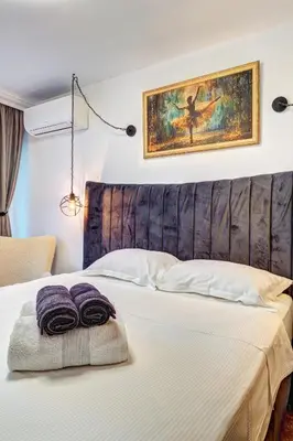 a hotel room with a bed with towels on it at Boutique Apartment DOLCHE VITA in Smolyan