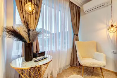 a room with a table and a chair and a window at Boutique Apartment DOLCHE VITA in Smolyan